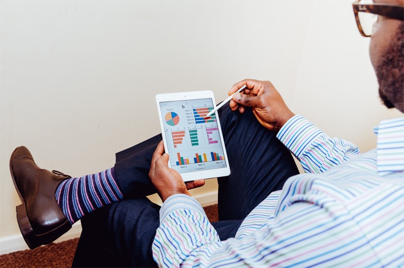 A man doing business on an tablet.
